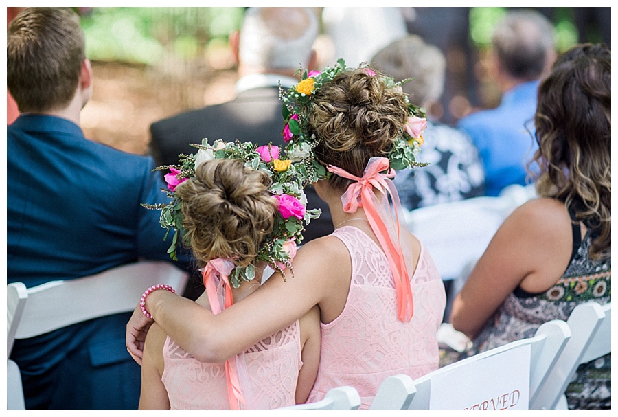 flower girls hugging each other at outdoor wedding ceremony at the Farm at Dover