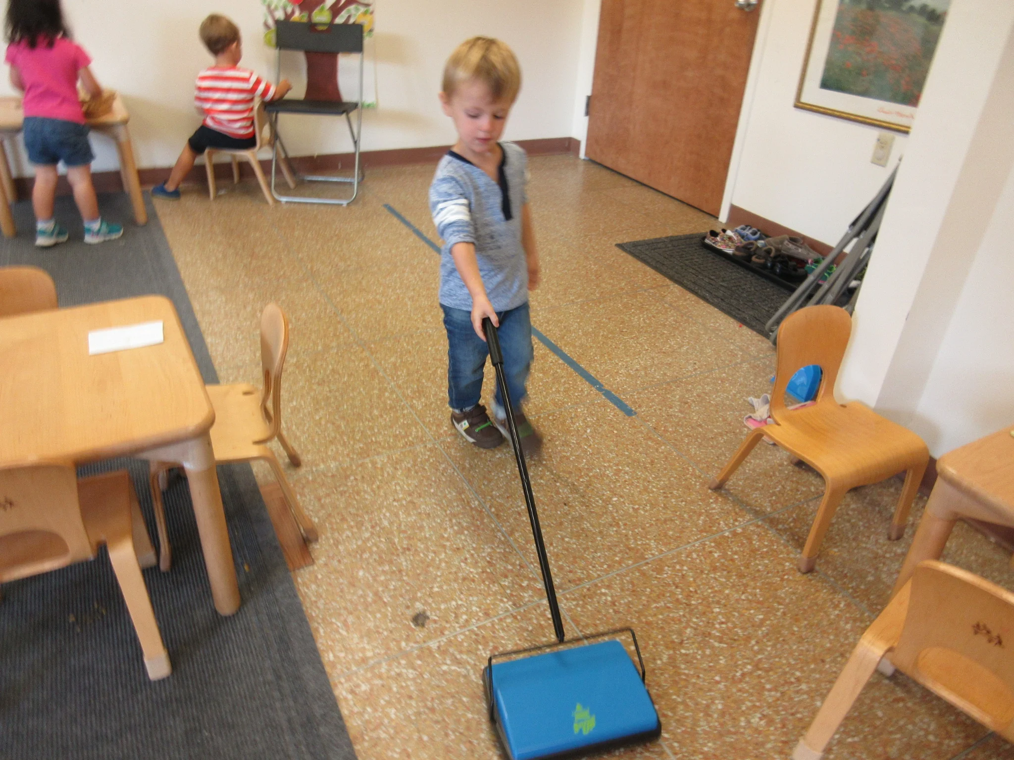 Helping to sweep the floor after a snack spilled 