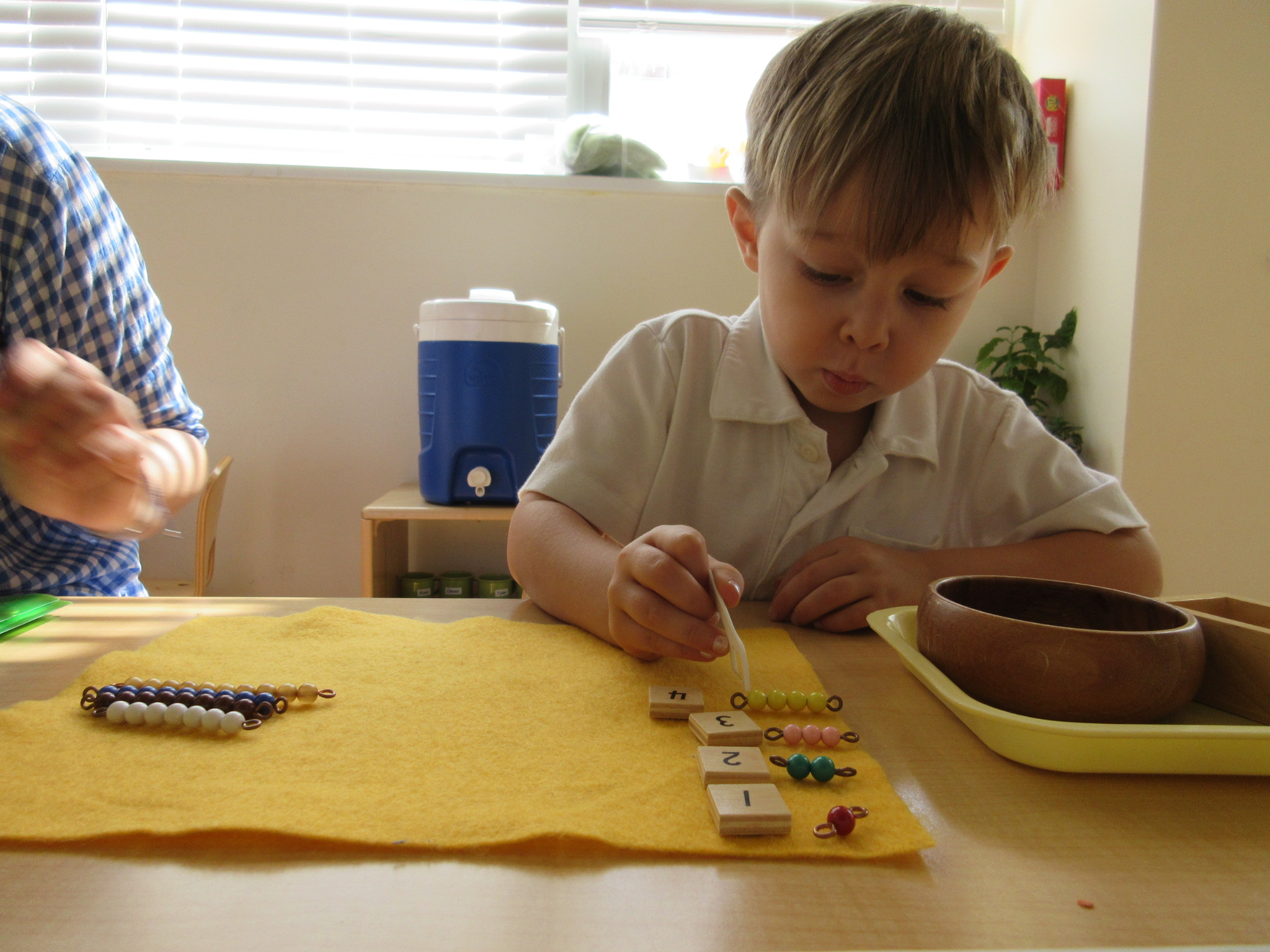 A child counts using the Bead Stair.