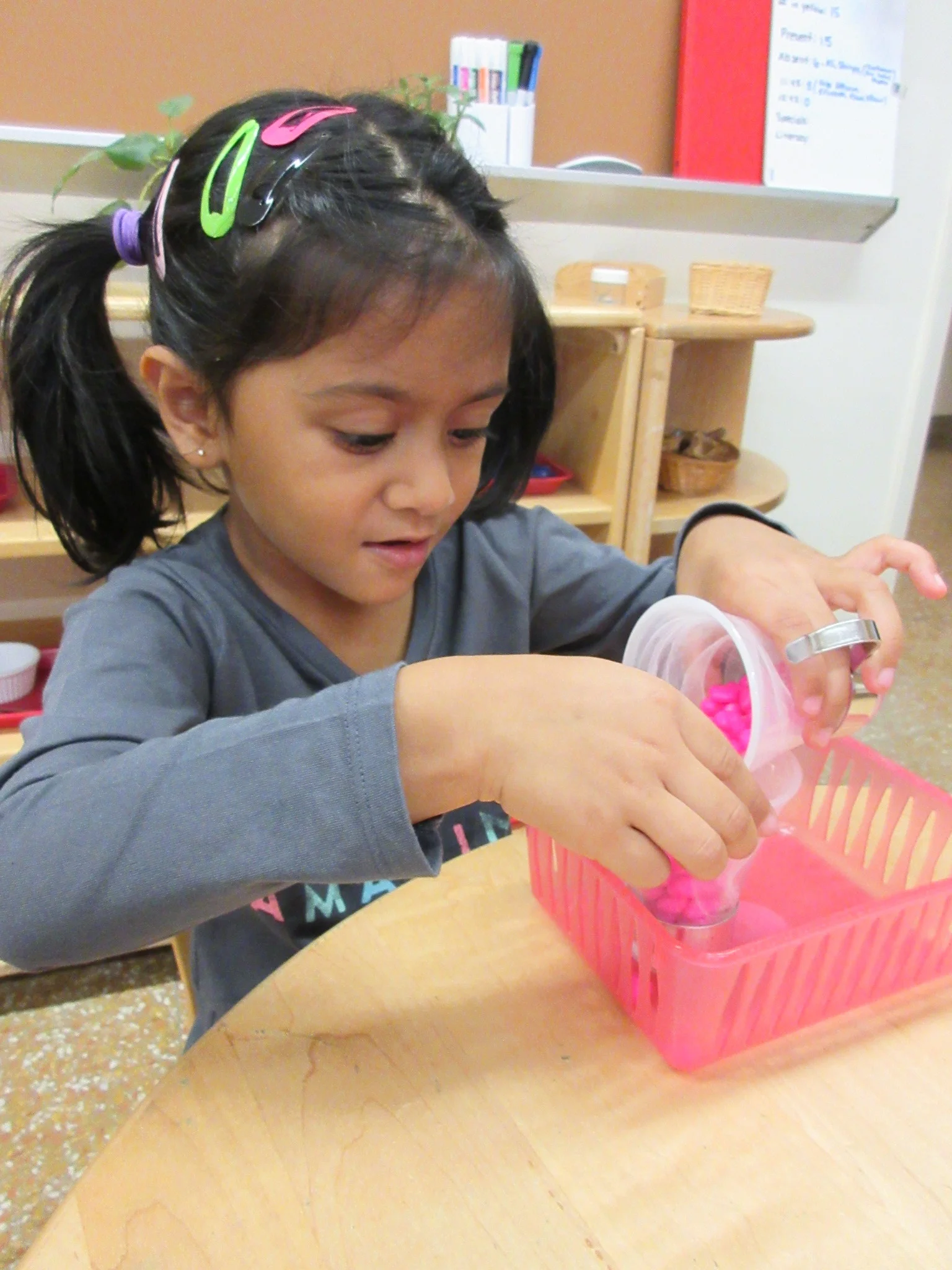 Practicing pouring without spilling a stone.