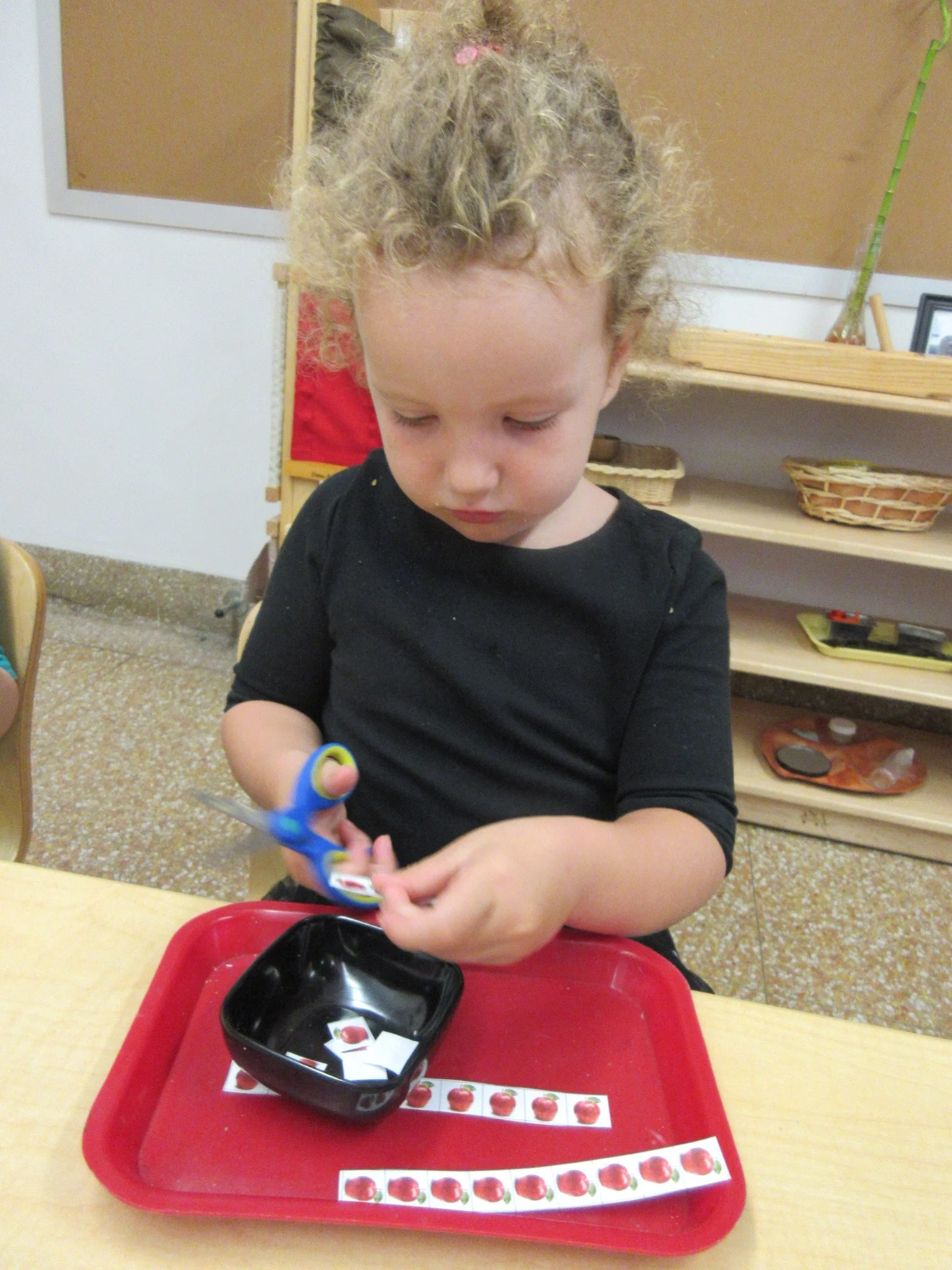 Practicing cutting on a line and counting apples too!