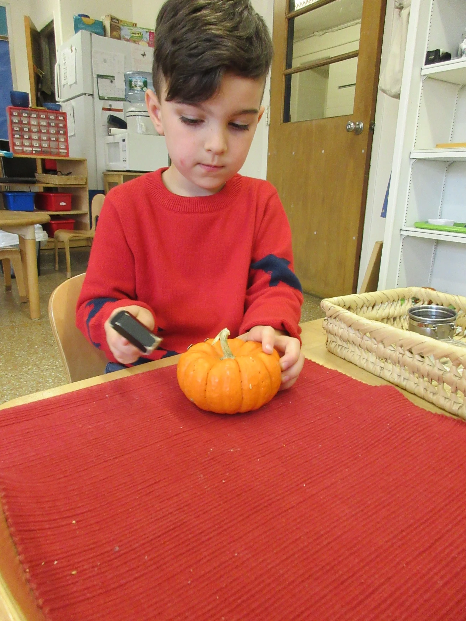 Hammering tacks into a pumpkin 