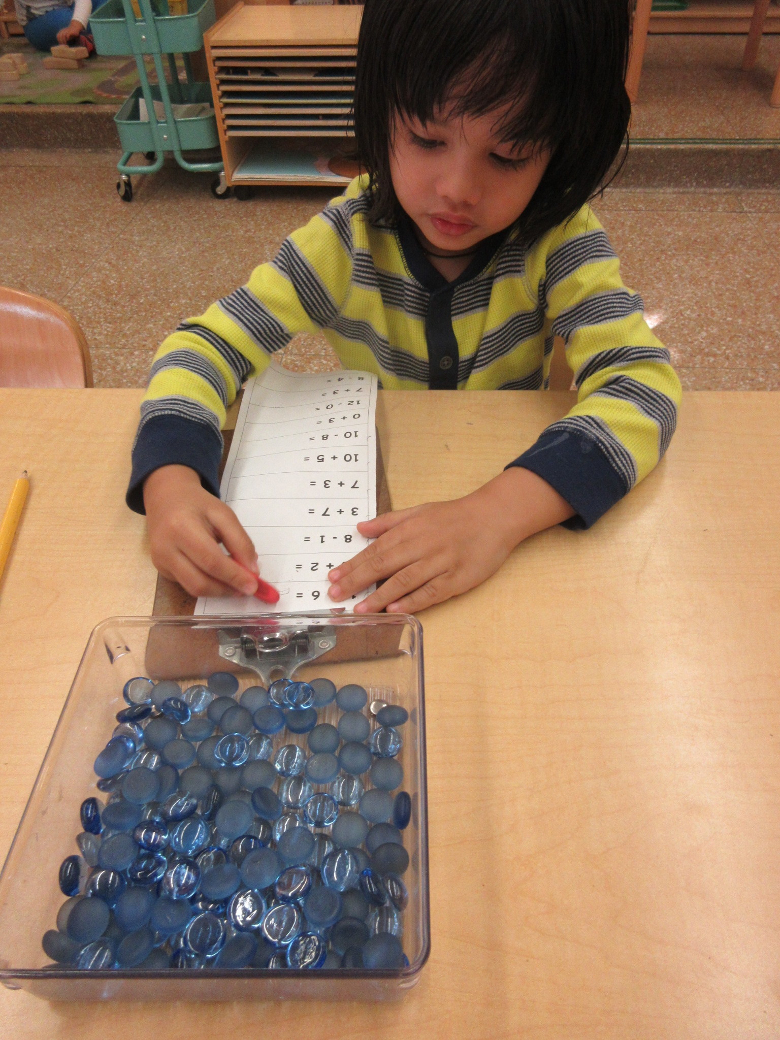 Working on addition and subtraction equations with counters.