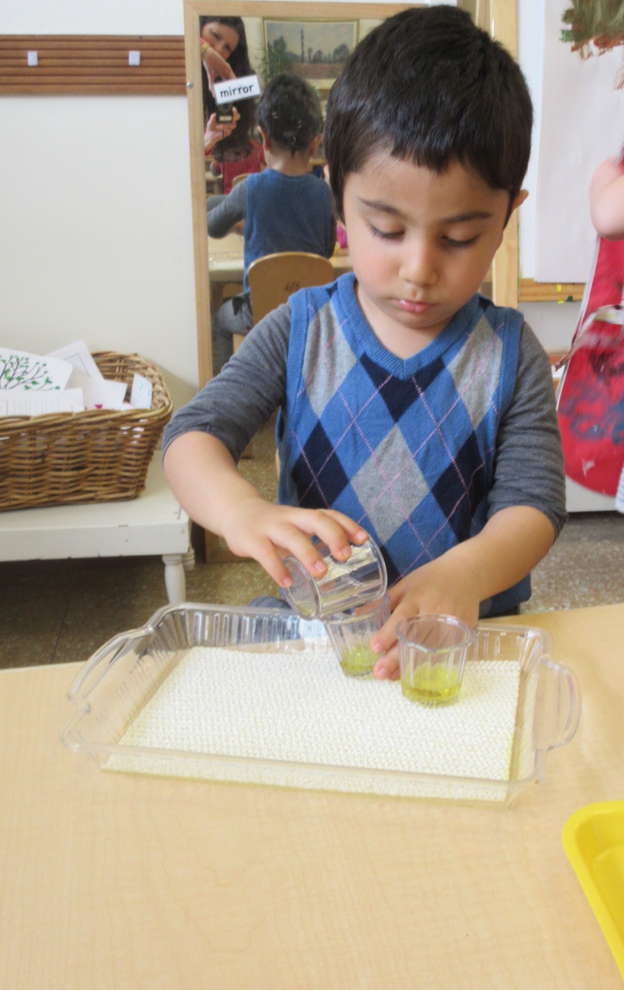 Dexterity! Pouring colored water from a larger container to two smaller containers