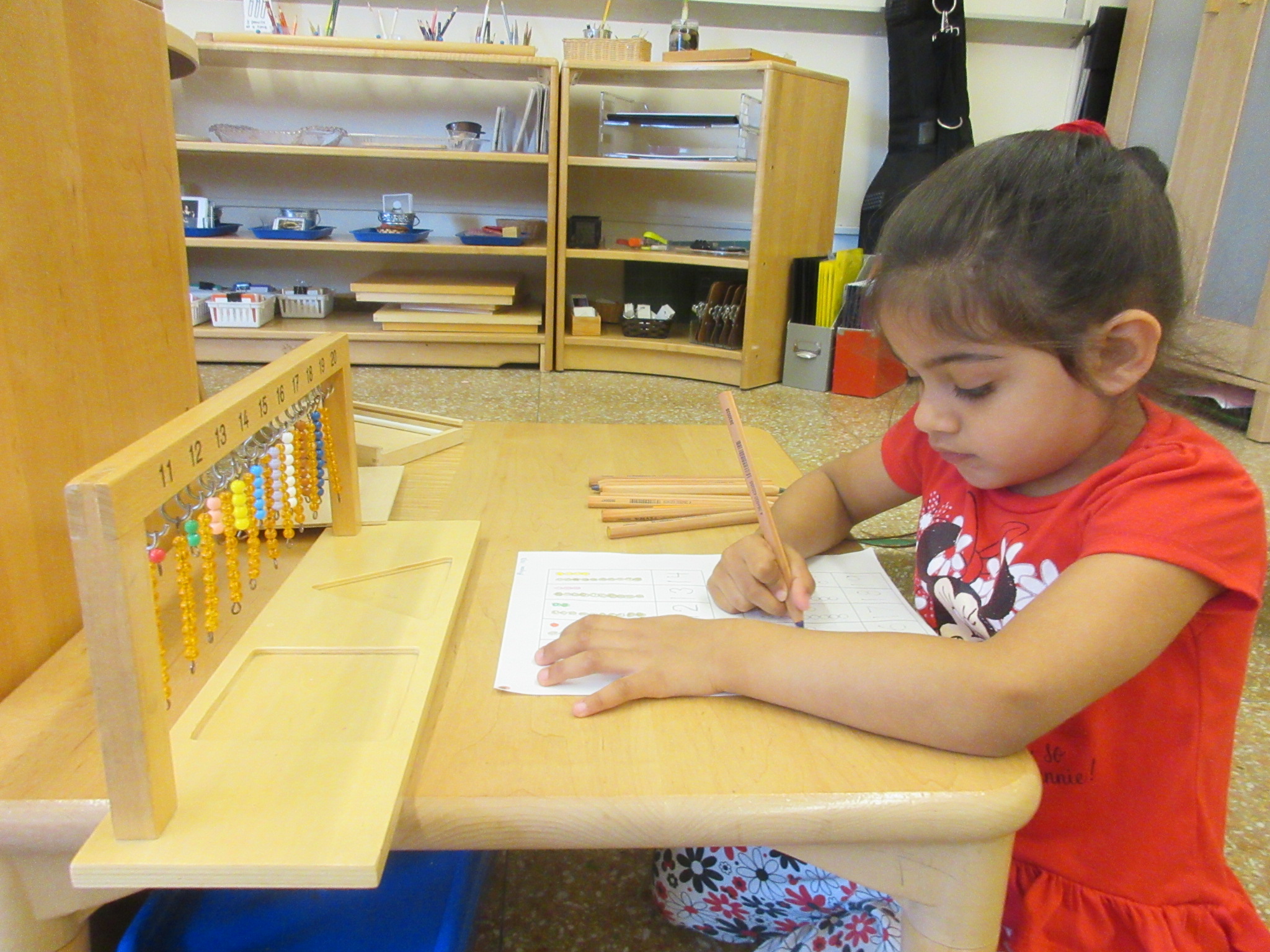 Concentrating hard on her Hanging Teens work.