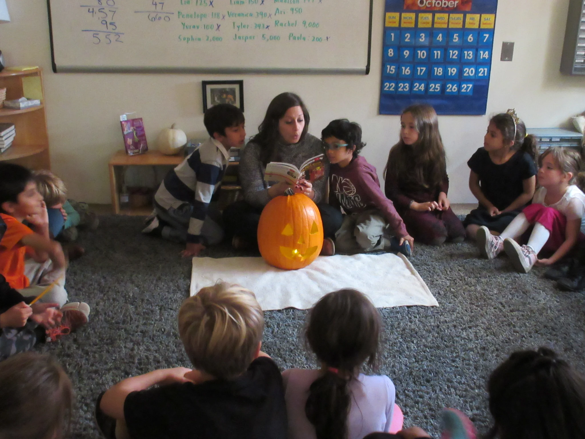 Reading with our jack o lantern, an Earth Room tradition 