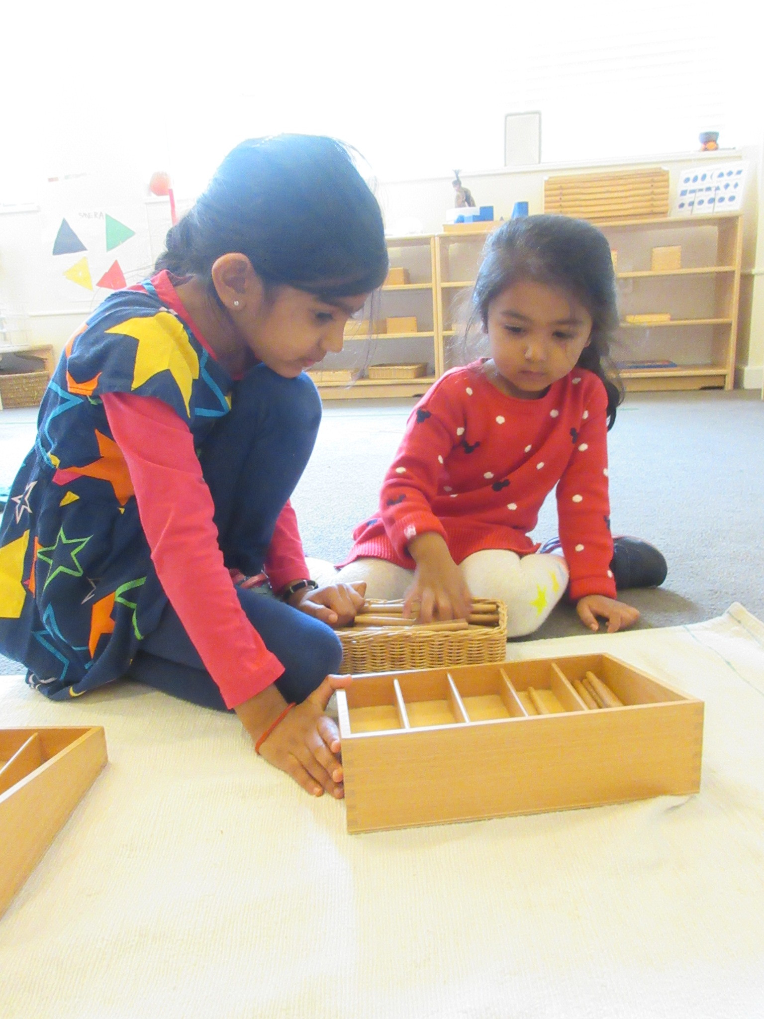 Giving a lesson to a younger friend with the spindle box