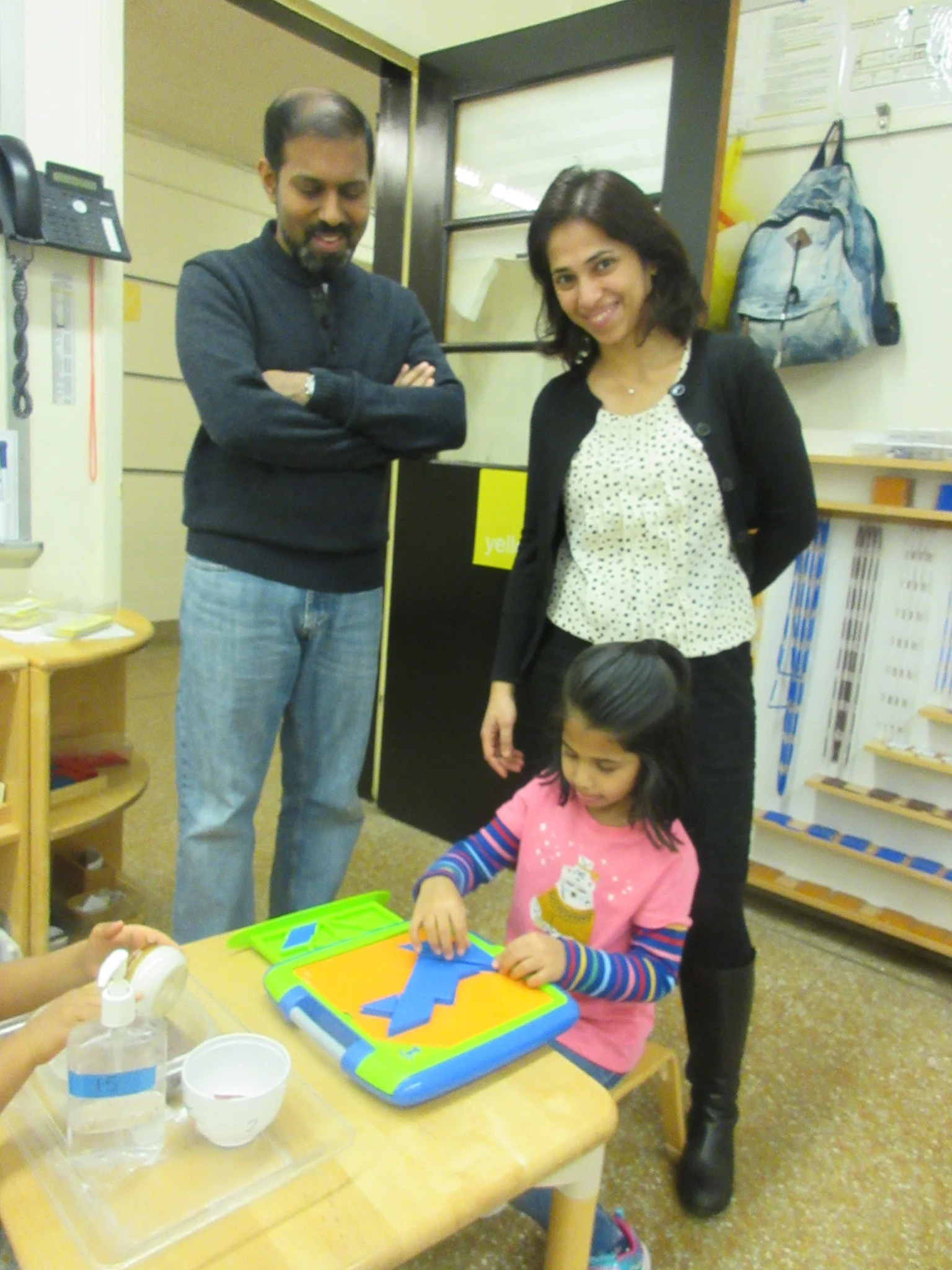Work with your child week: Showing her parents a new work of different  geometric shapes in the classroom.