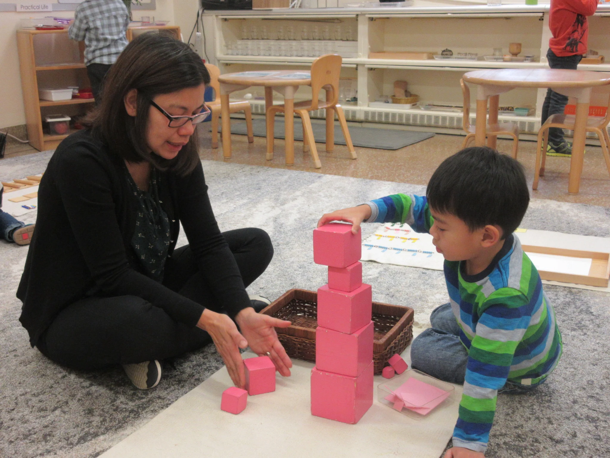 Work with your child week: Building Pink Tower with his mom.