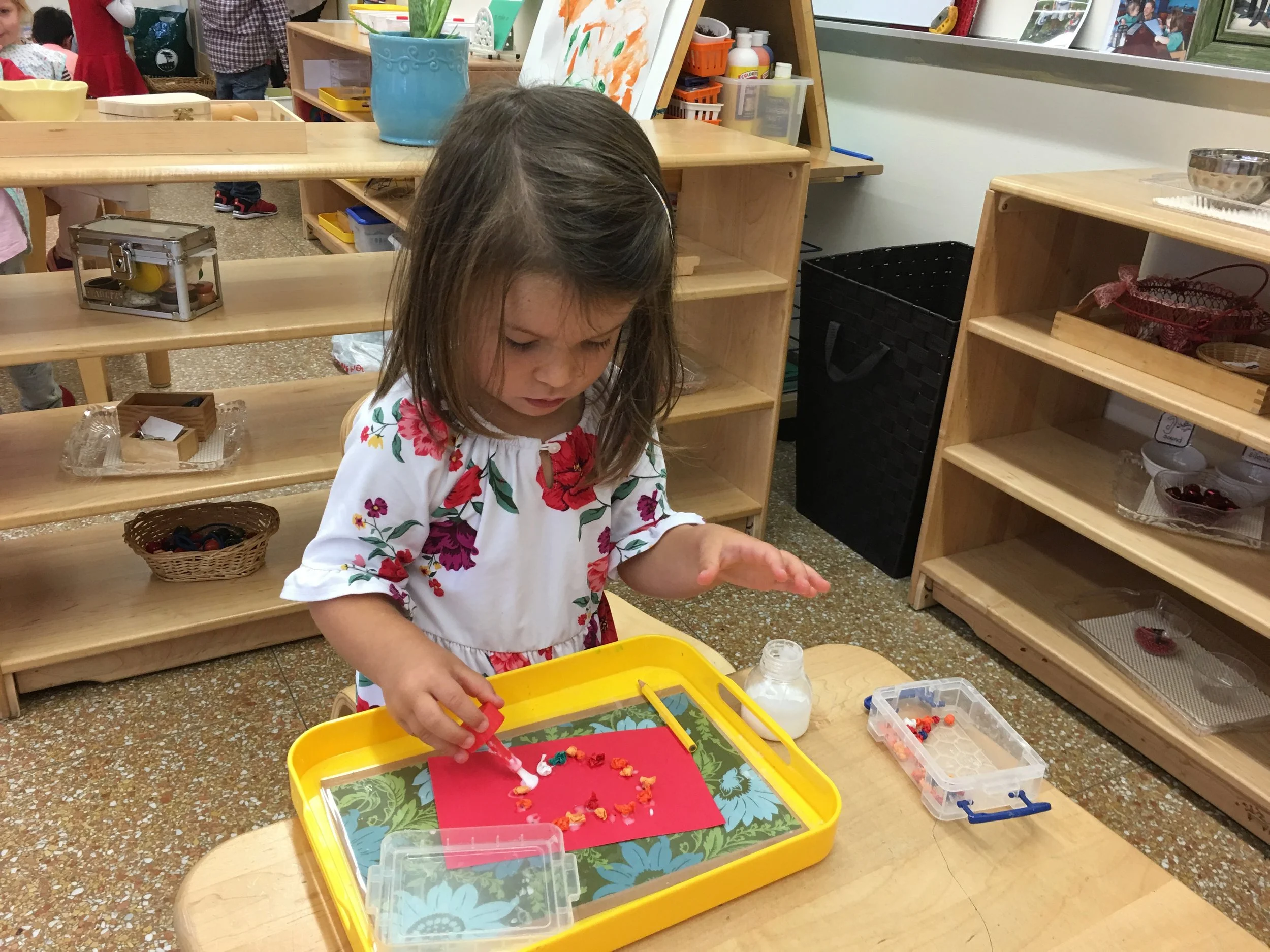 Creating beautiful shapes by gluing each individual piece of tissue paper.