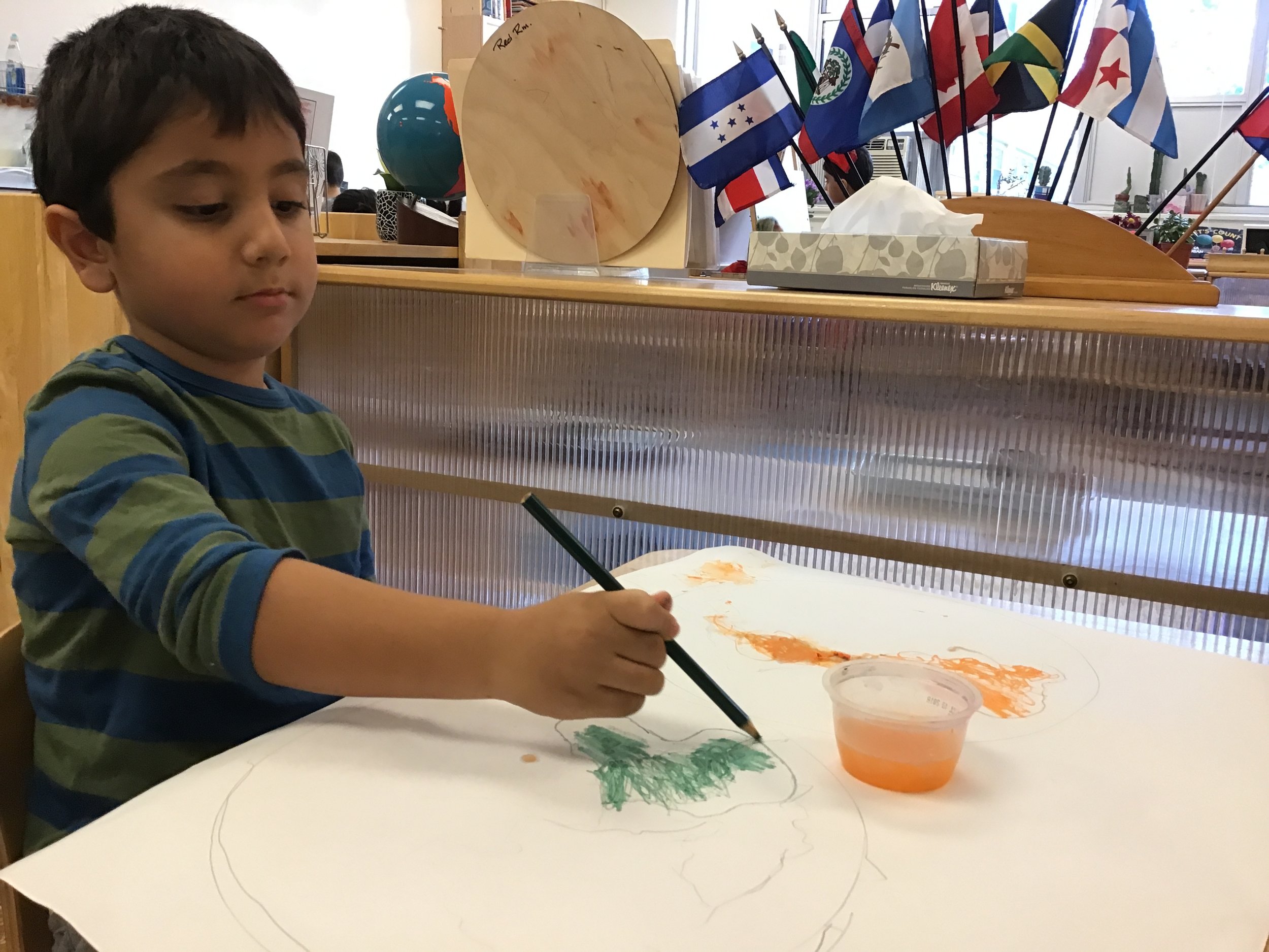 Using watercolor pencils to make a world map 