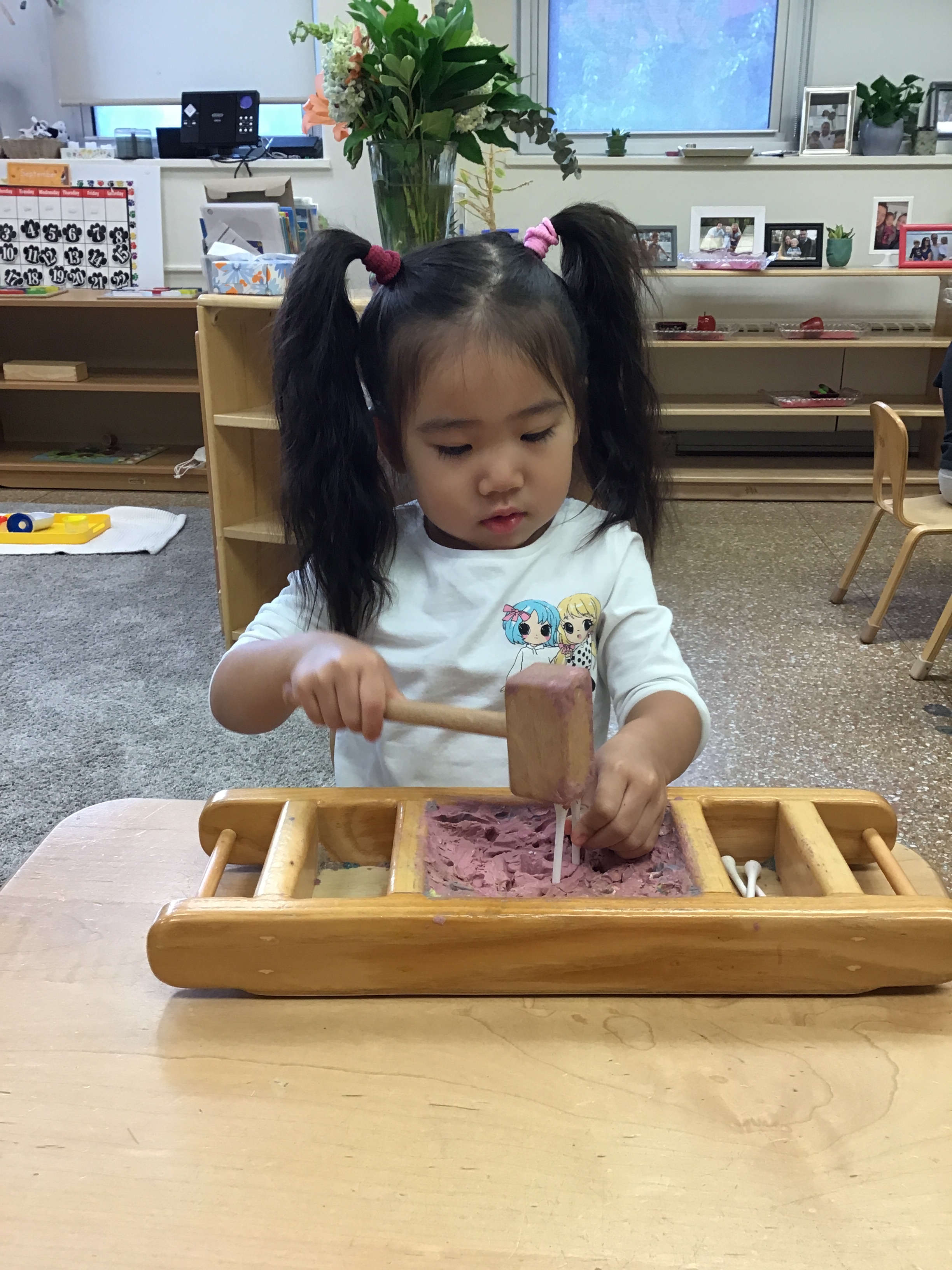 Hammering pegs strengthens fine motor skills and hand-eye coordination.