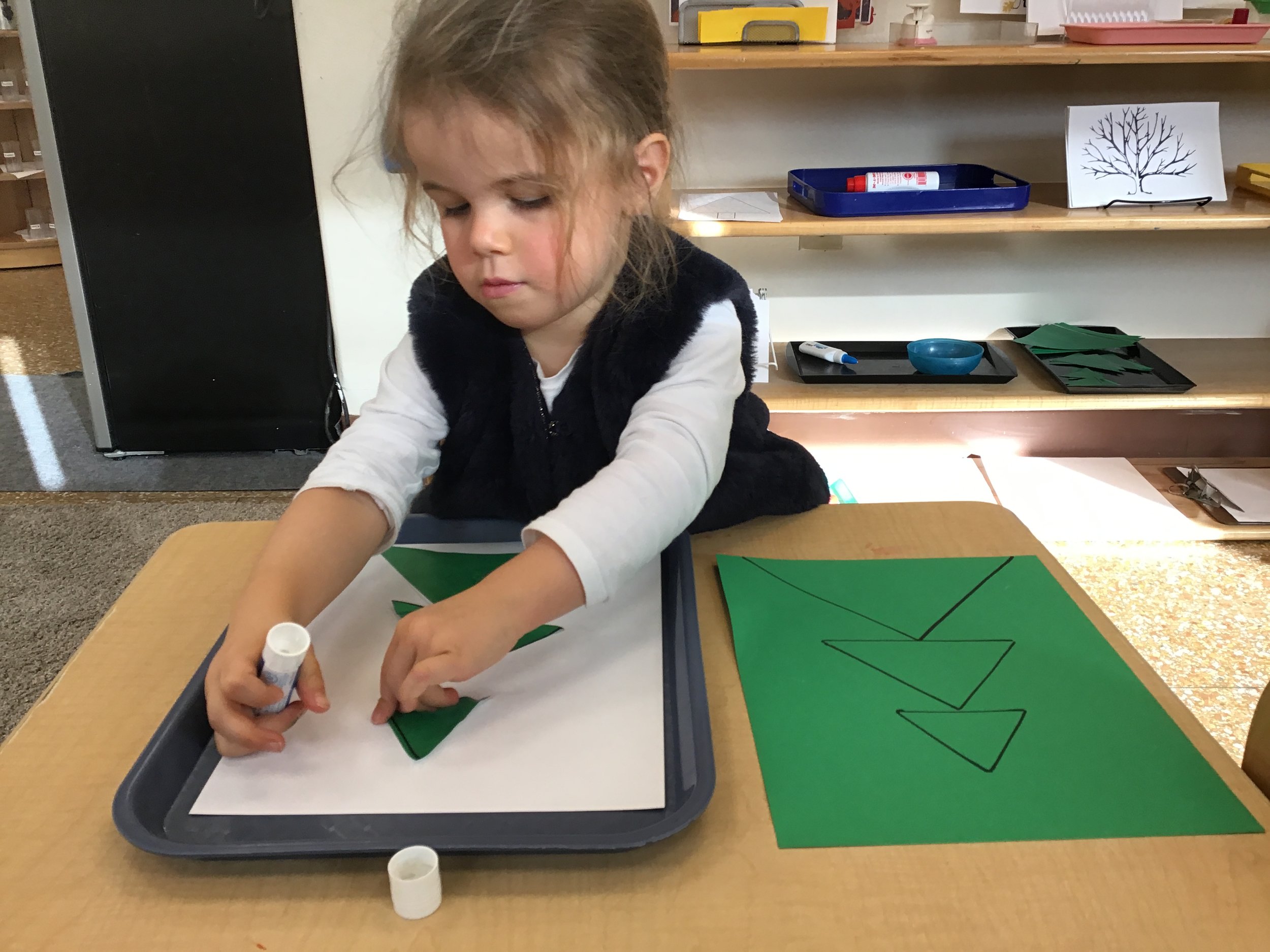 Stacking triangles from largest to smallest to make a tree.