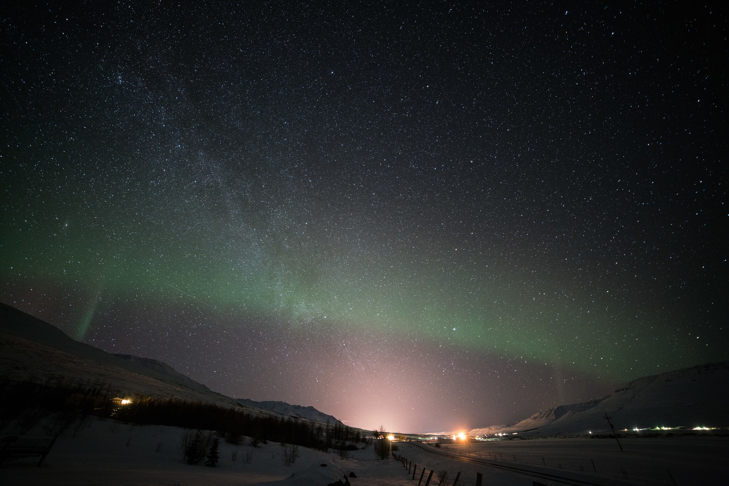 The Northern Lights just starting to peek out, dulled a bit by the glow of Akureyri. March 2, 2016. A7rII with Rokinon 14mm f/2.8, ISO 3200, 30s.