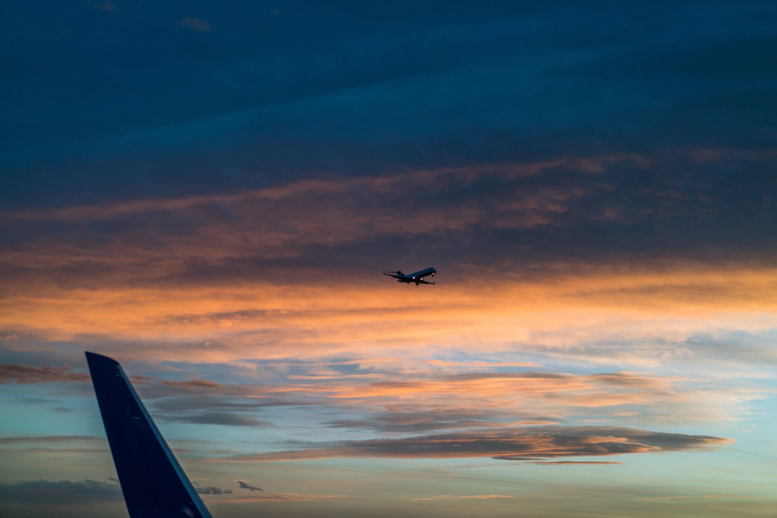 Watching a plane land while waiting for takeoff at Denver