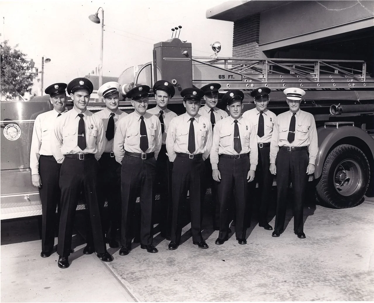 LATE 50'S , AT OLD HQ. , 115 E. BROADWAY  ( 6621 LADDER TRUCK ) -ED DANIEL, JIM GESLER , CHARLIE RUSSELL , JIM HEYING , JAMES MC MAHON  DON  BERGER , AUGIE FITZ , DUANE CARPENTER , BOBBIE PHILLIPS , E