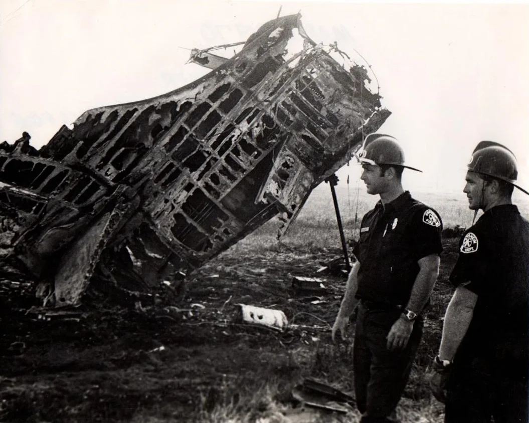 DOUG BEERY AND RANDY SARVER AT SITE OF U.S. NAVY JET CRASH ACROSS FROM ANAHEIM STADIUM , THE PILOT EJECTED SAFELY AND CAME WALKING UP CARRYING HIS PARACHUTE 1969