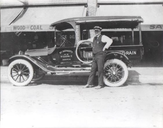 Bill Duckworth with his 1912 Dodge truck , he was paid $2.00 to hitch up to the hand drawn hose cart and pull it to the fire , thus saving energy of firemen to fight the fire .