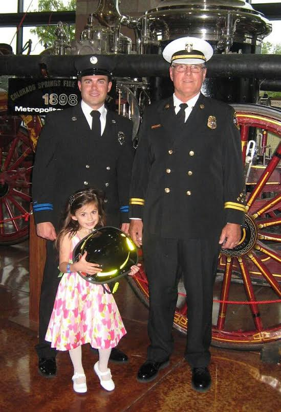 Battalion Chief Ken Anderson and son  Engineer Ken Anderson Colorado Springs FD with granddaughter Faith