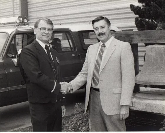 FIRE CHIEF HARTSHORN (right) PROMOTES MIKE DOTY TO POSITION OF FIRE MARSHALL , 1985 