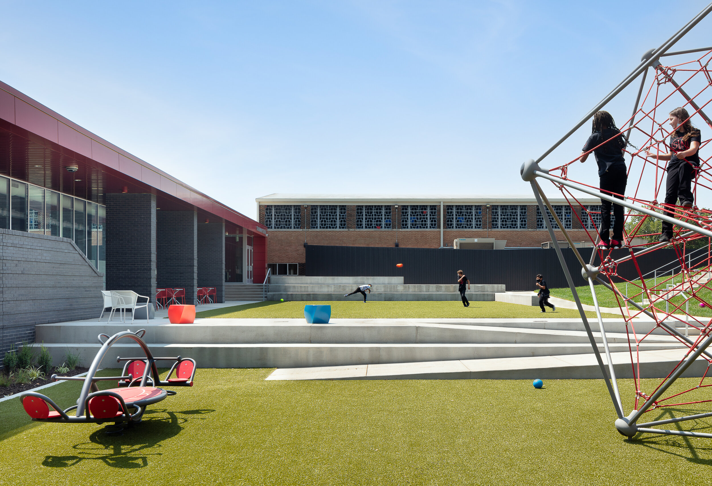  Back exterior, turf and play equipment w/ old building in the background. 