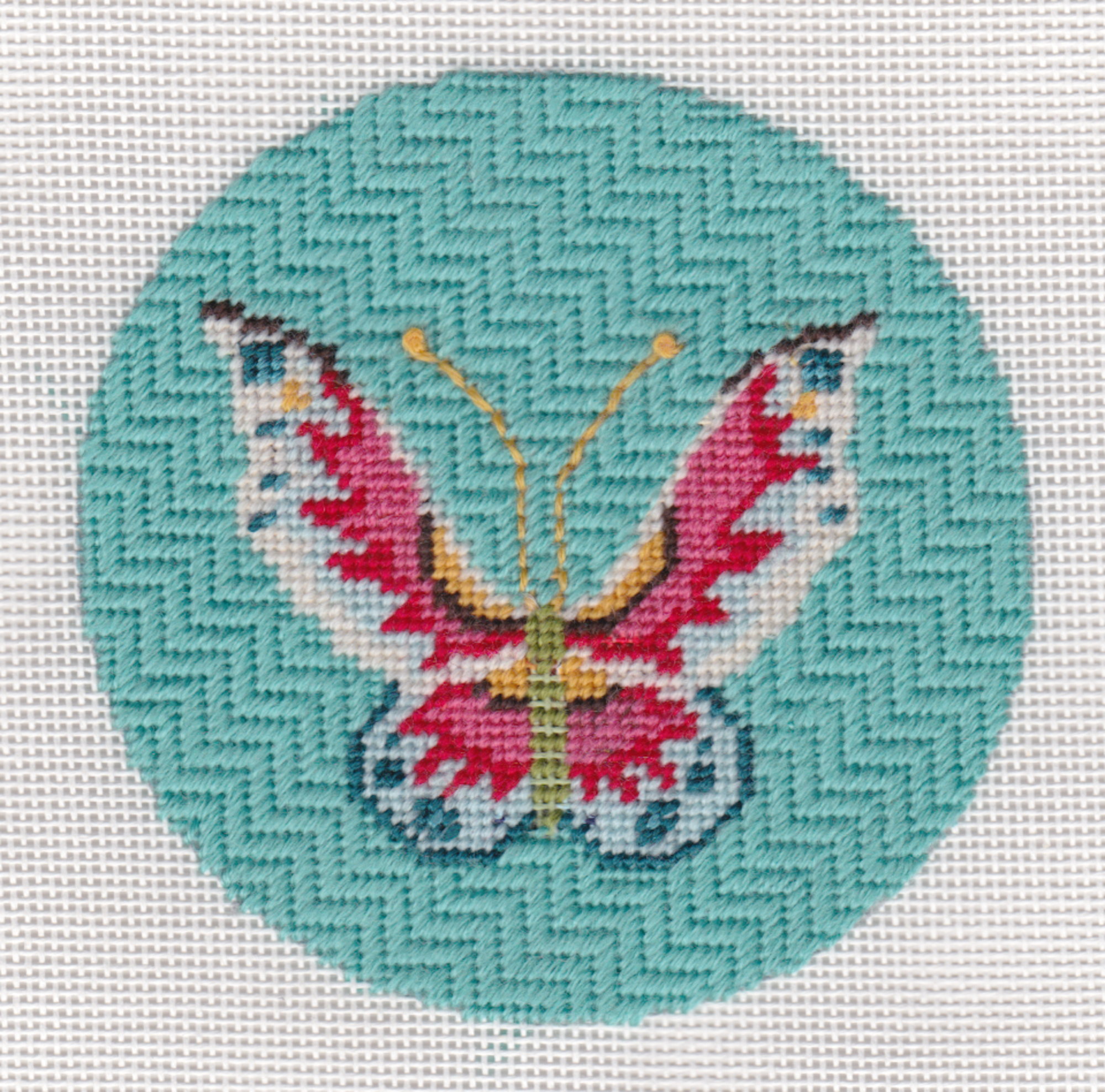 The design area measures 4 inches round and is stitch-painted on 18 ct. mesh mono Zweigart needlepoint canvas.