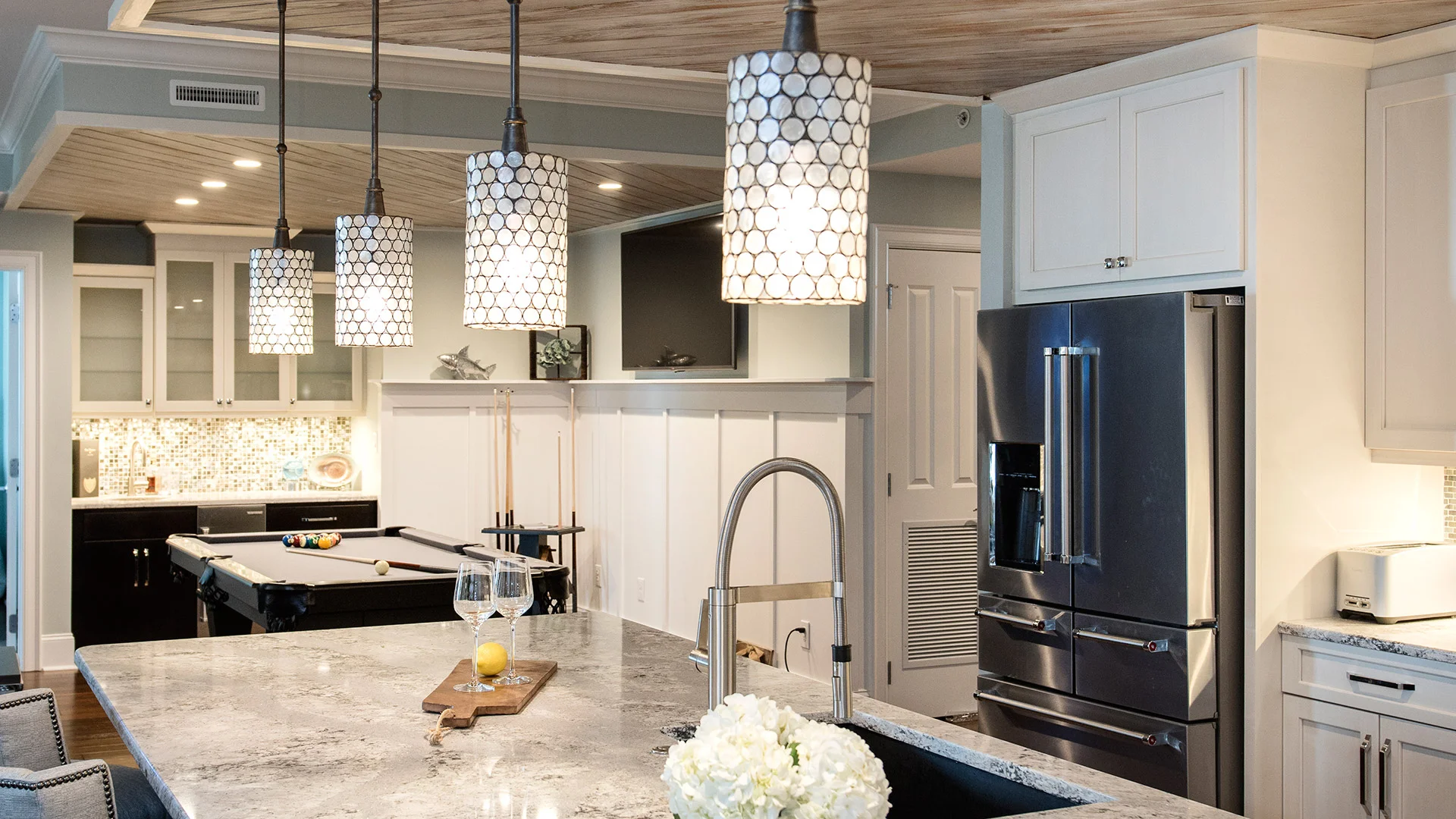 From 90s to contemporary beach, this condo underwent a major transformation. Updates in this Grande Villas condo at Indian Beach, NC were made from the flooring to the ceiling + wall to wall with beautiful beachy backsplash additions, new cabinetry, an electric fireplace, unique lighting, state-of-the-art appliances + a custom wine cellar!