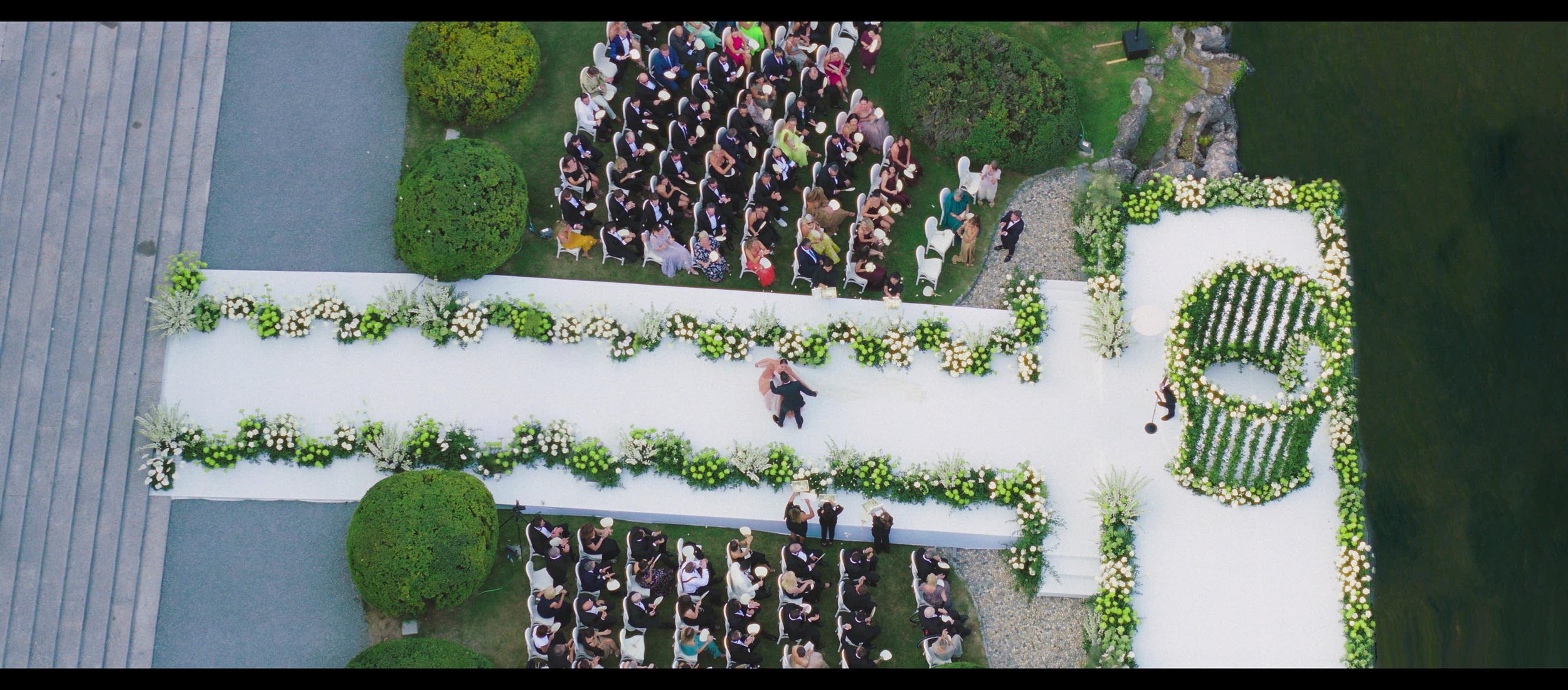 Luxury wedding drone shot ceremony exit at villa erba lake como with Alejandra Poupel and Sacks Productions