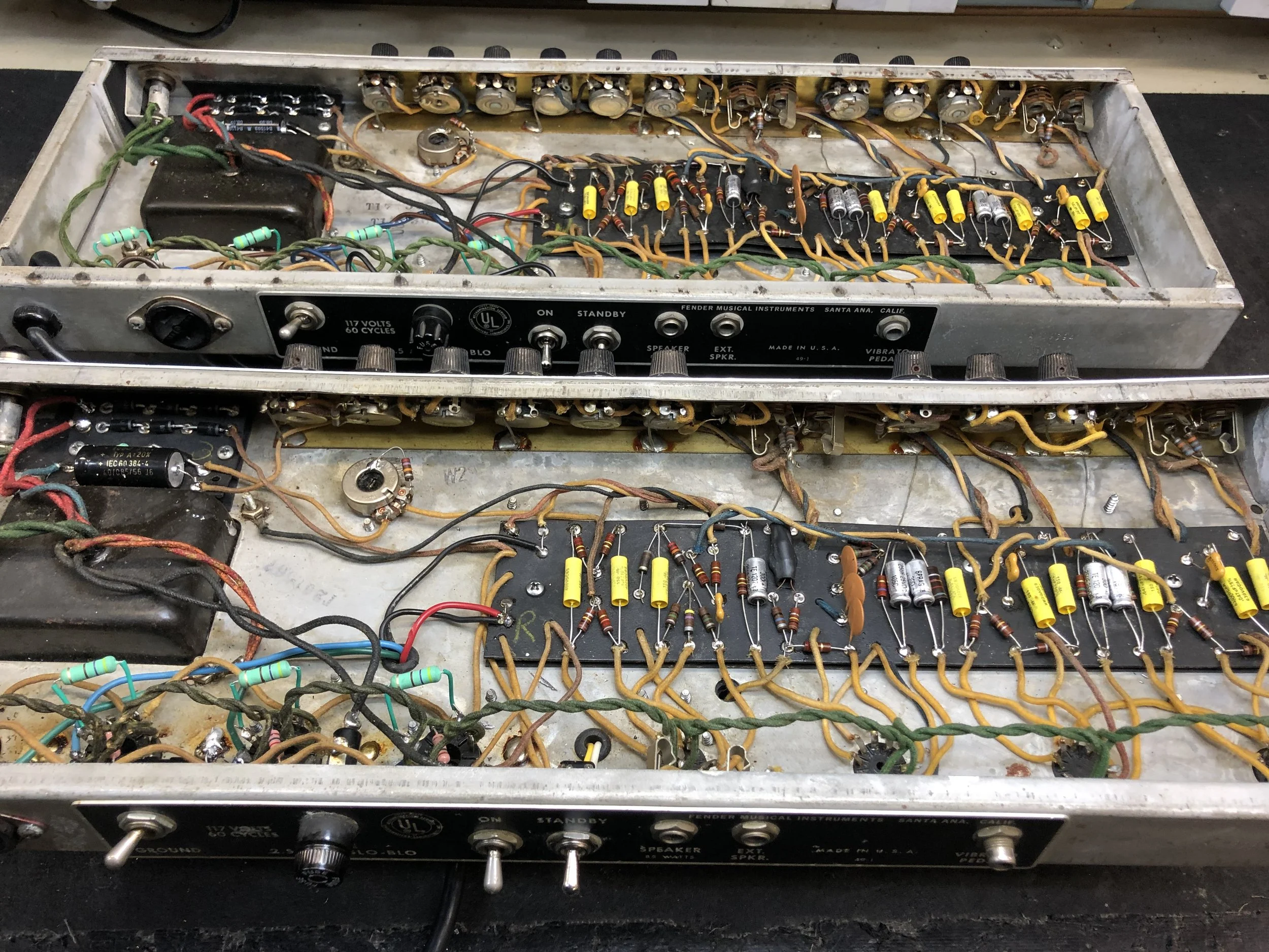 Vintage electronic musical instrument with exposed internal components, including resistors and capacitors, housed in a metal casing with control knobs on the front panel.