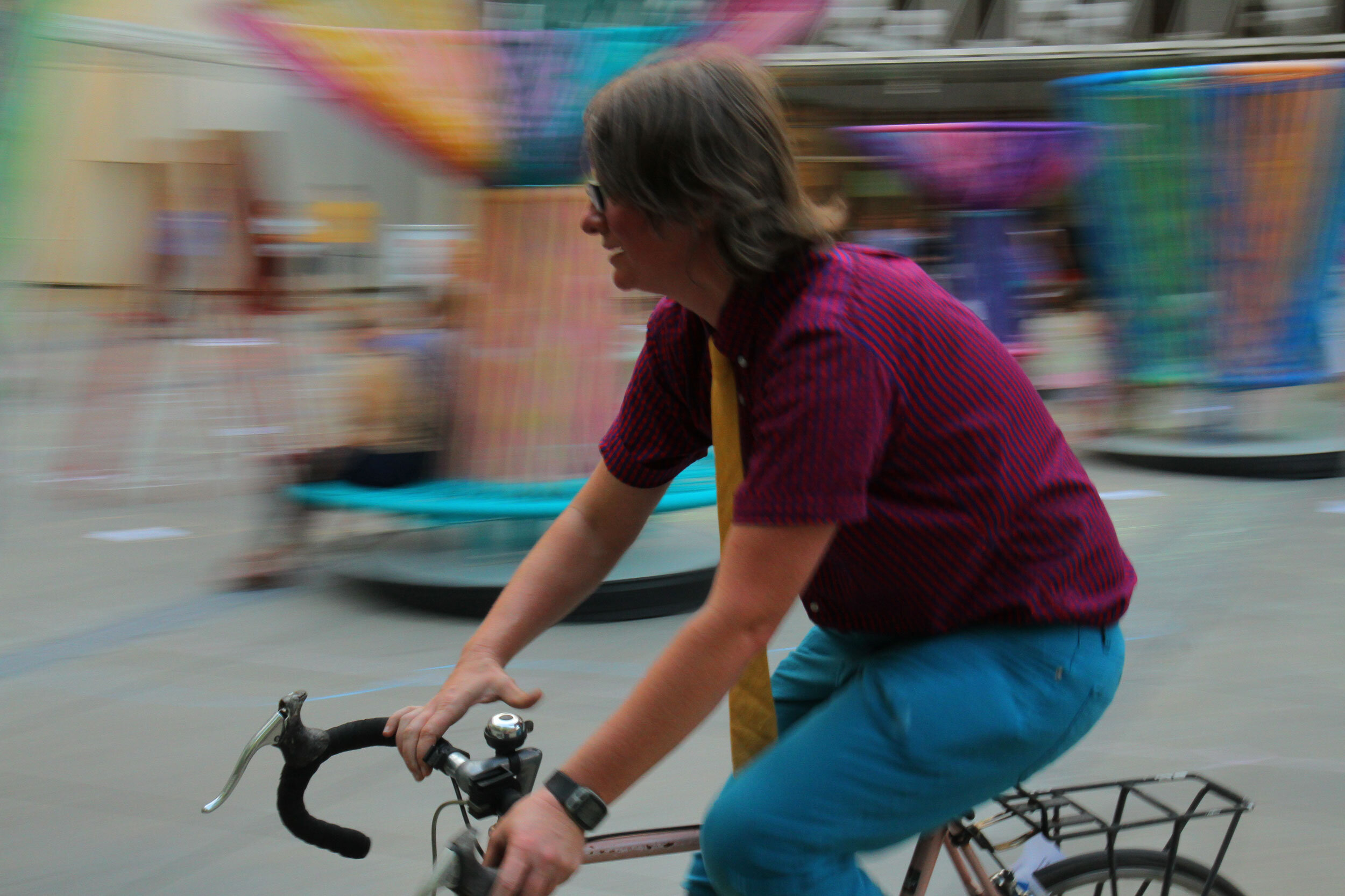 A performer on a bicycle moving past the camera.