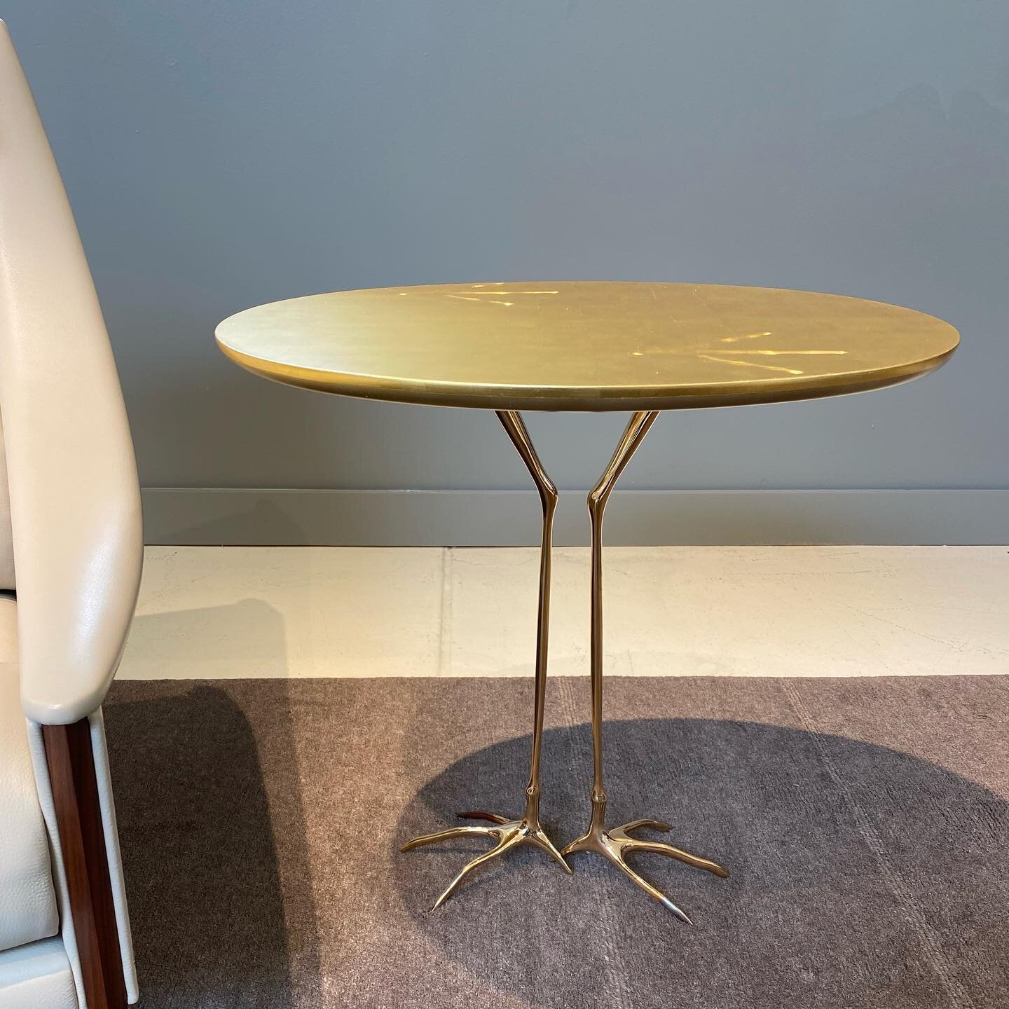 The TRACCIA side table, created in 1939 by Swiss Surrealist Meret Oppenheim, has slender, polished cast-bronze legs and feet (a tribute to classic &ldquo;claw-foot&rdquo; furniture of centuries past) and foot prints carved into an oval wooden top whi