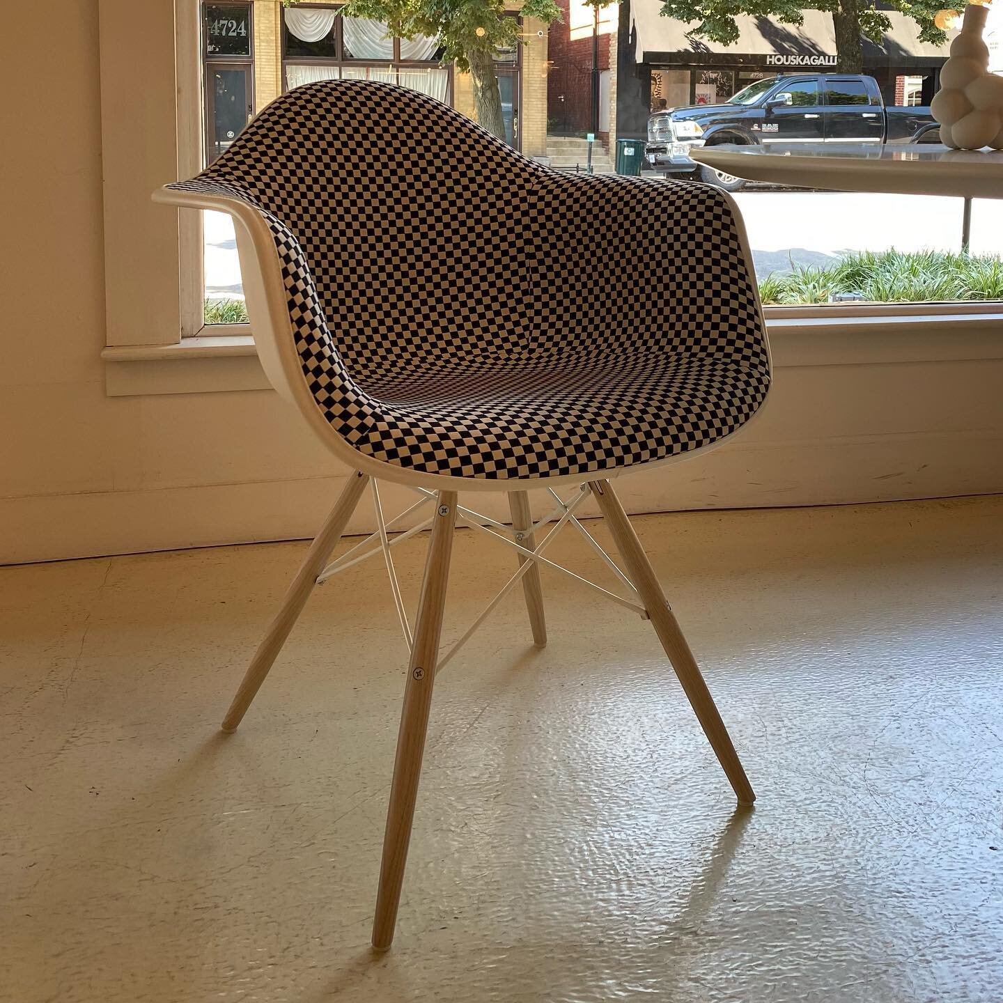 Just arrived from Herman Miller: our Eames Molded Plastic Armchair w/ Dowel Legs wears Maharam CHECKER fabric (designed in 1965 by Alexander Girard) while our Eames Wire Chair wears a black &ldquo;bikini&rdquo; of Maharam PRONE leather. What will you