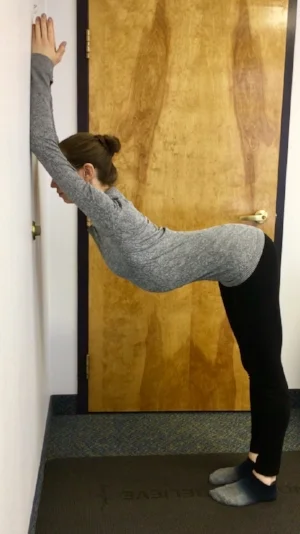 press elbows and forearms into the wall and walk feet back until they're under hips. Start with elbows shoulder height and work your way up until you feel a stretch along the sides and under the armpits. Reach back through the tailbone and breathe deeply. Hold for 8-10 breaths. 