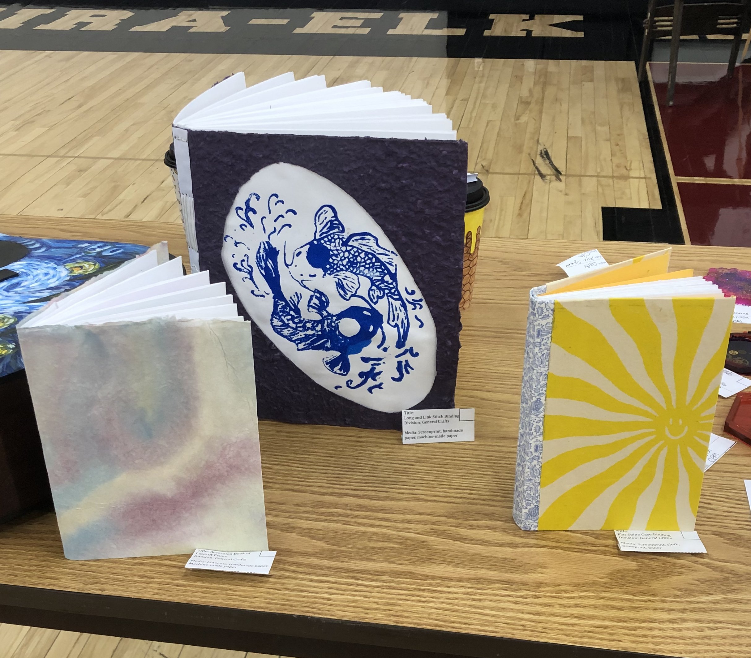 Student bookbinding examples with handmade papers and prints