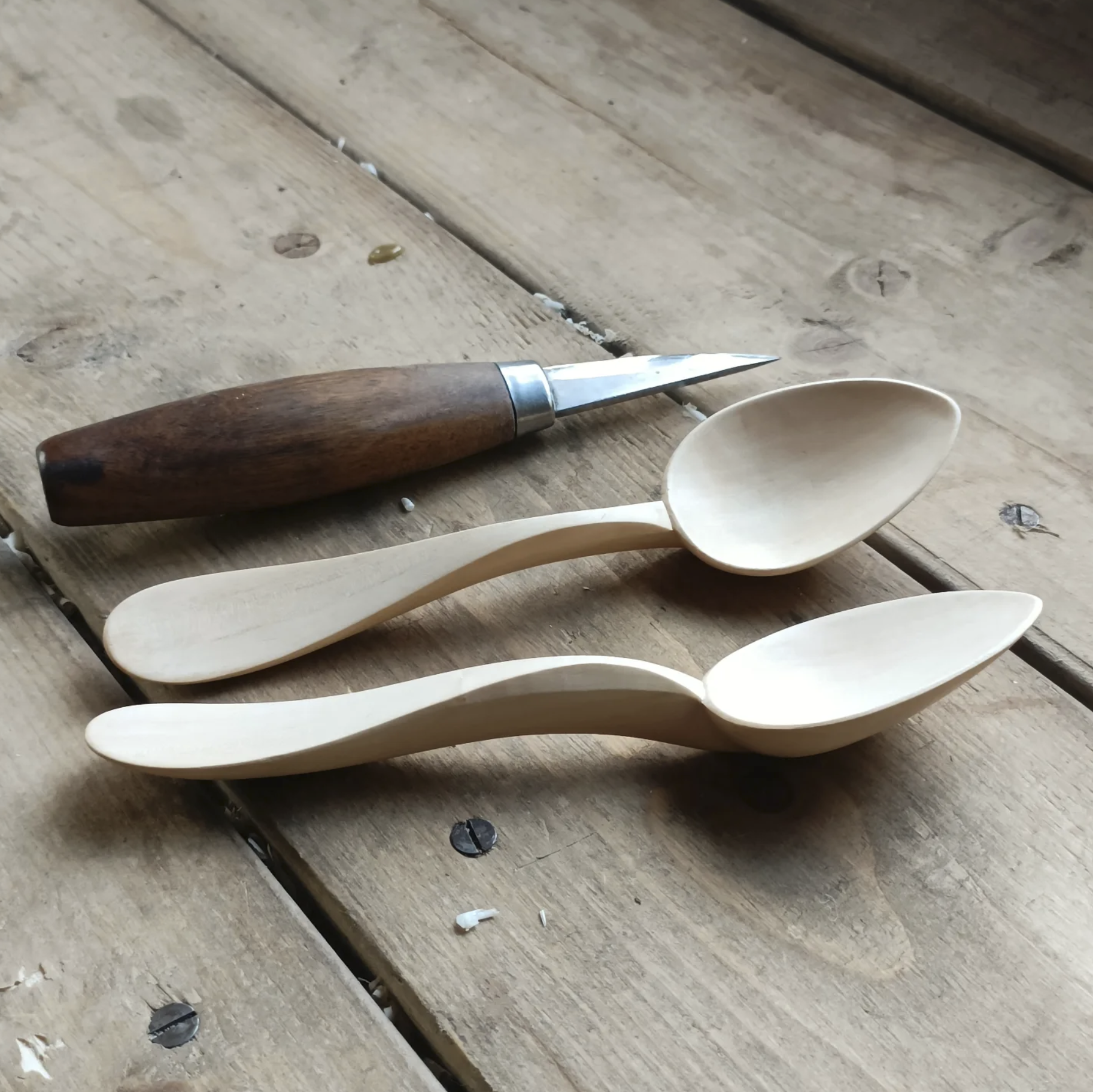 Two hand carved wooden spoons