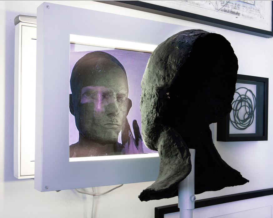 Marc Fichou, Plastron , 2010, video sculpture, 19 x18 x15 inches. LCD monitor, neon light system, two way mirror, steel, plastic, plaster, paint.