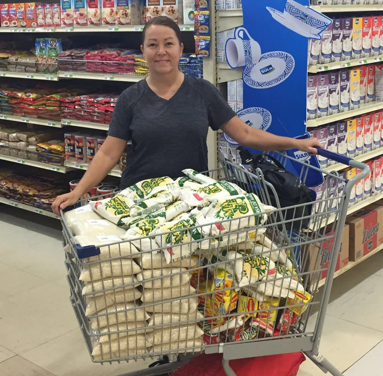 Our founder and missionary, Robyn, buying groceries to fill the back packs