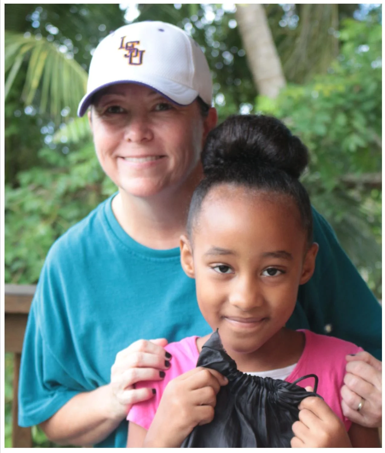 Our missionary, Robyn, with one of the children who receives a back pack of food each week