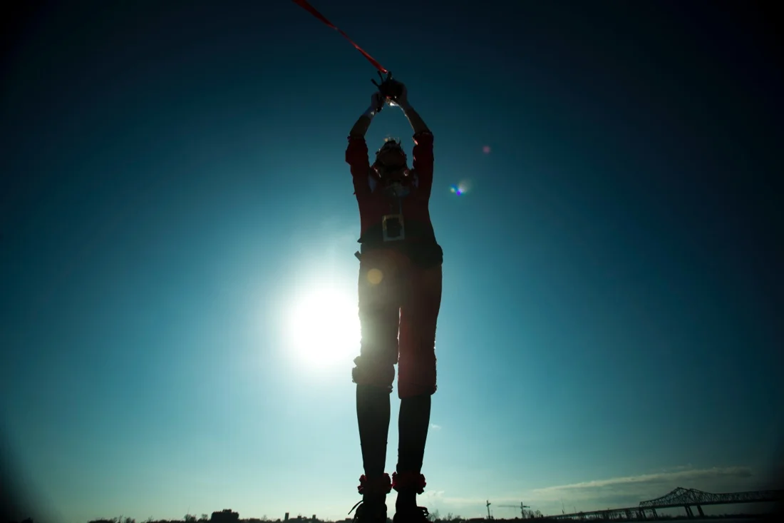 new orleans mardi gras 2014 - droppin' feathers production shot 13; silhoutted flagger mississippi river.jpg
