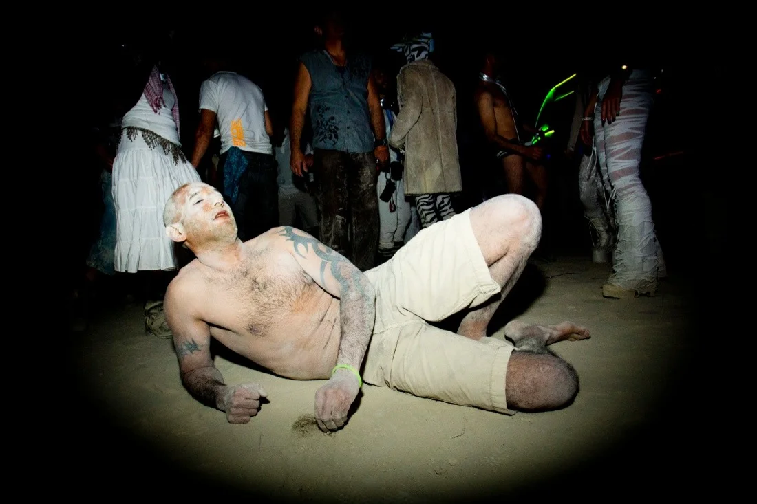 burning man 2013 161; guy dancing on the ground dust.jpg