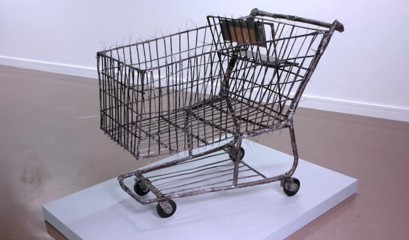 "In the Future We'll Build Our Shopping Carts from Sticks and Twigs So We Can Stock Up on the Bones of Our Children" (scavenged sticks and twigs, India ink, paint, wire and cardboard), by John Christian Anderson, in his show "My Inheritance,'' throu…