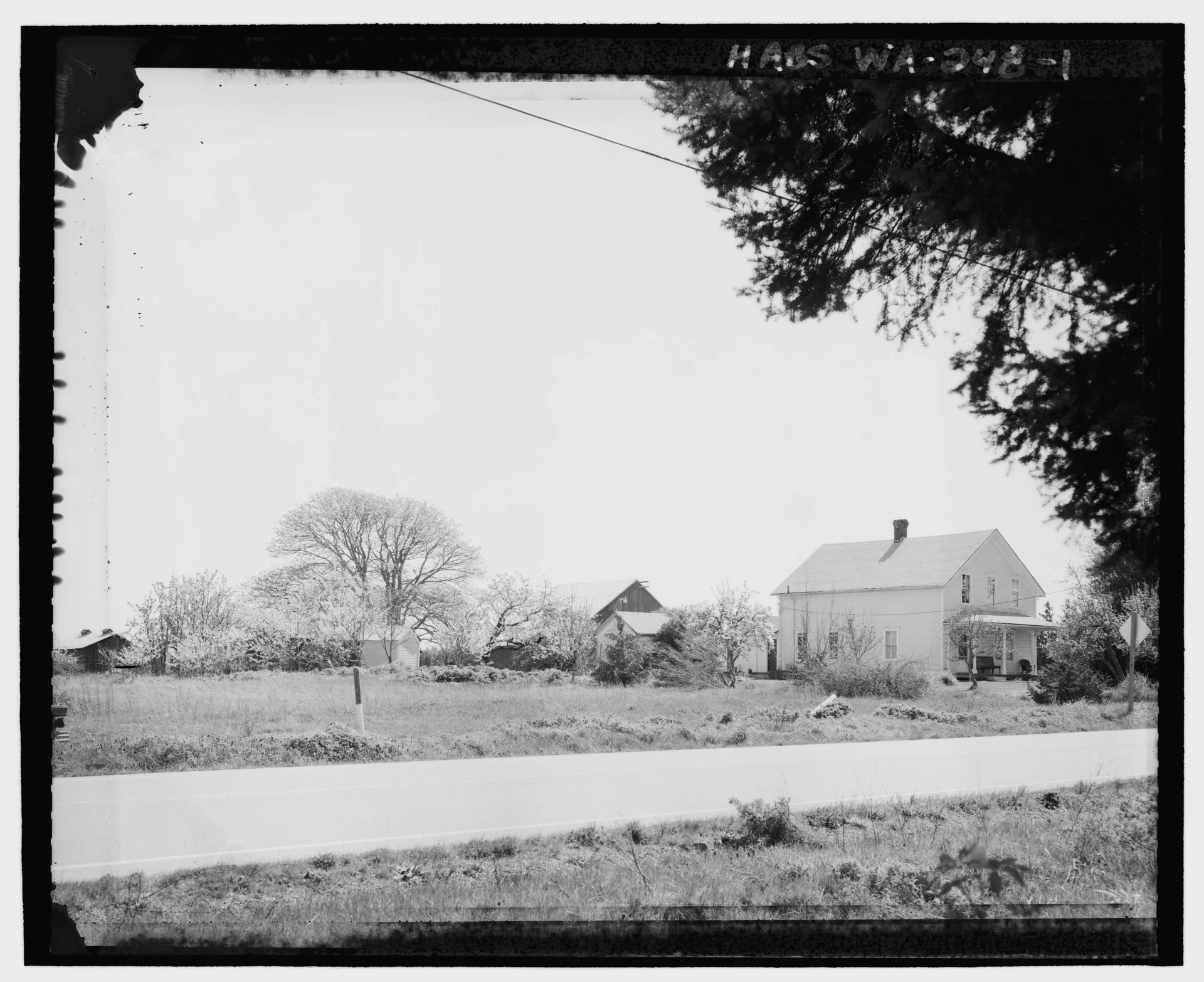 KINETH_FARM_FROM_ACROSS_HIGHWAY_20,_LOOKING_SOUTHEAST._The_Kineth_house_is_seen_on_the_right,_facing_the_highway._Behind_the_house_the_milk_house,_out_house,_and_a_chicken_coop_are_shown_HABS_WA-248-1.tif.jpg