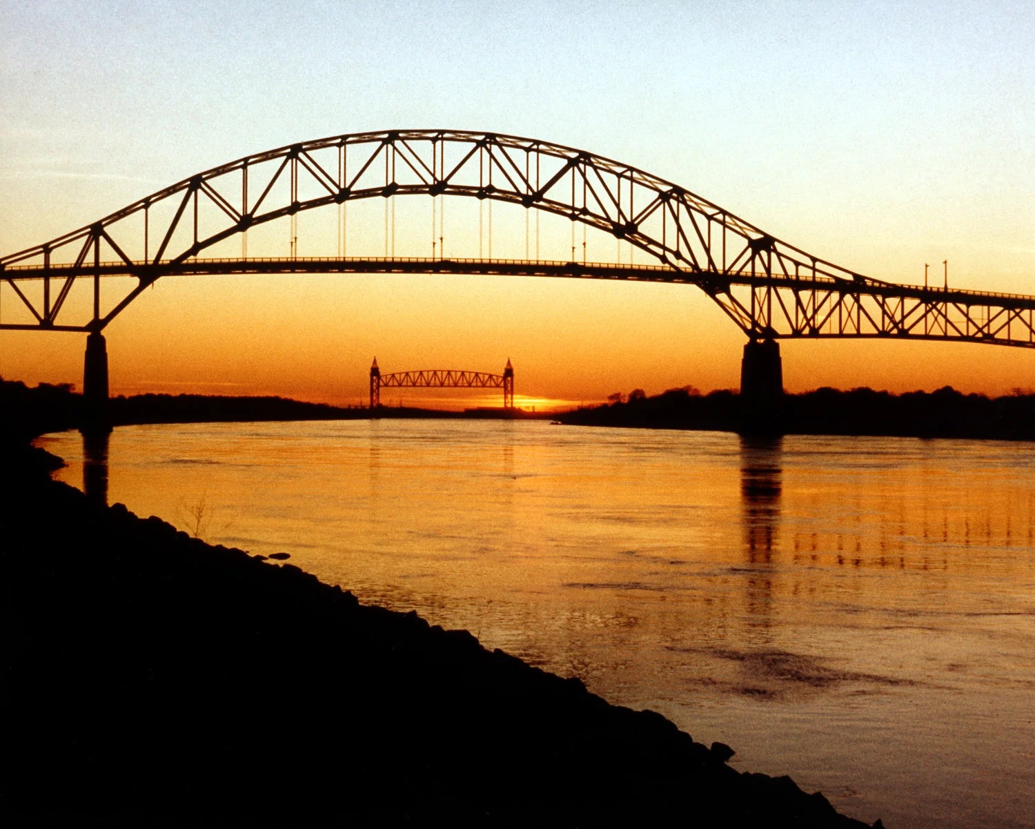The Bourne Bridge over the Cape Cod Canal, with the Canal Railroad Bridge in the distance.