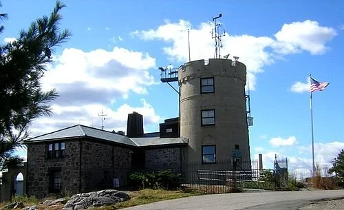 The Blue Hill Meteorological Observatory, on top of Great Blue Hill, in Milton, founded in 1884, is the oldest continuously operating weather recording station in North America . It was also the location of the earliest kite soundings of the atmosphere in North America, in the 1890s, as well as the development of the radiosonde , in the 1930s. During the Great New England Hurricane of 1938 , the observatory measured the strongest wind gust ever directly measured and recorded in a hurricane in North America, at 186 mph, at which point the wind disabled the measuring device. Some have estimated that the gusts may have reached 200 mph in the storm. The site was chosen because the elevation of 635 feet is the highest point within 10 miles of the Atlantic on the East C oast south of central Maine.