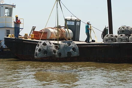 Reef balls being dropped into an area to lure fish in the Gulf of Mexico
