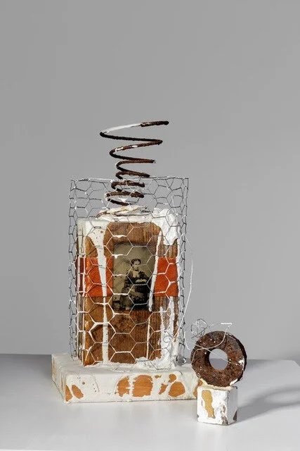 “Emily’’ (mixed media), by Joe Caruso, in Galatea Fine Art’s (Boston) online gallery.This text runs with it:“She stares out of a prison of an unknown making, complacent in her captivity. The woman's image in this construction seems unaware that time…