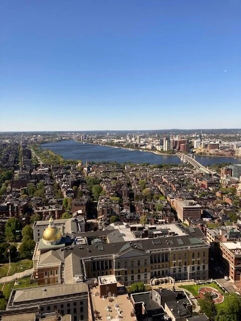 View from the 32 floor of One Beacon Street, Boston, with the dome of the State House at the left and Charles River Basin and Cambridge further out.— Robert Whitcomb