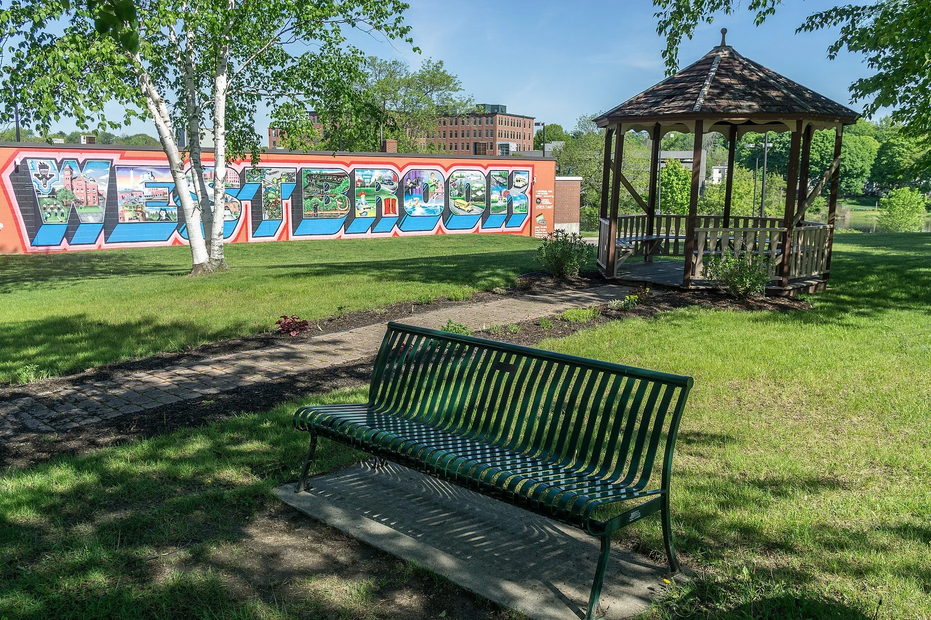This sign and gazebo are across the street from the Westbrook Public Library. The mural was a project of Westbrook Arts &amp; Culture, painted by aerosol artist Mike Rich and funded by the Warren Memorial Foundation and several Westbrook businesses. See the old mill building in the distance.