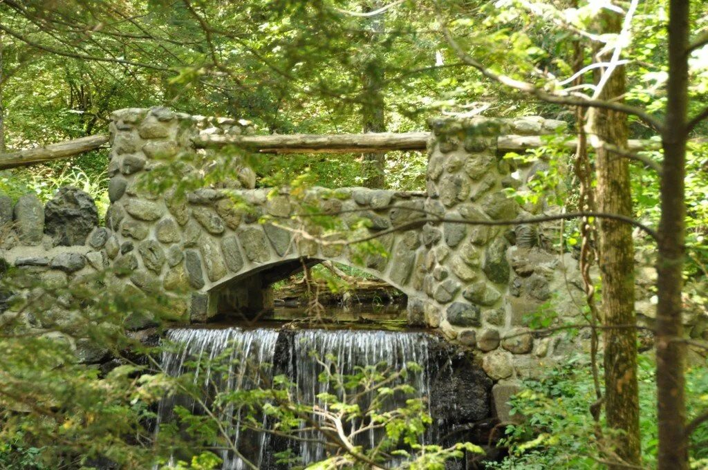 A stone foot bridge crossing an 18th Century dam in the&nbsp;Spot Pond Archeological District&nbsp;of the&nbsp;Middlesex Fells Reservation&nbsp;in&nbsp;Stoneham, Mass.— Photo by User:Magicpiano&nbsp;The Middlesex Fells Reservation, often called simply as The Fells, is a public recreation area covering more than 2,200 acres in Malden, Medford, Melrose, Stoneham and Winchester, Mass. The state park surrounds two inactive reservoirs, Spot Pond and the Fells Reservoir, and the three active reservoirs (North, Middle, and South) supplying  Winchester.