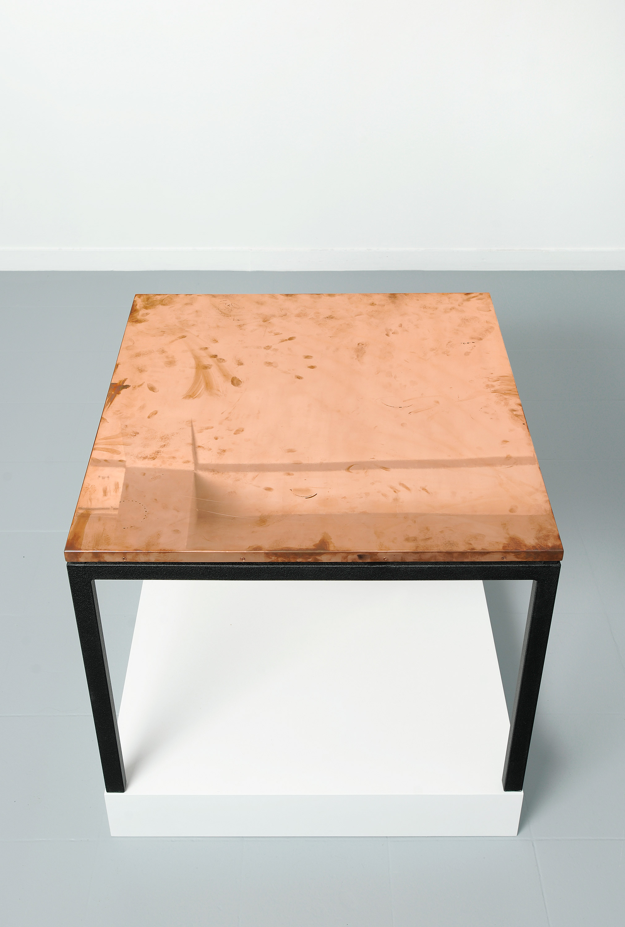   Copper Surrogate (Table: designed by Charlotte Perriand and Le Corbusier, 1959; Galerie Rodolphe Janssen, Brussels, Belgium, August 10th–September 2nd, 2011)    2011   Polished copper table top and powder-coat steel  Table: 33 5/8 x 33 5/8 x 1 inch